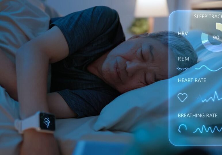 Man sleeping with wearable sleep tracking device.