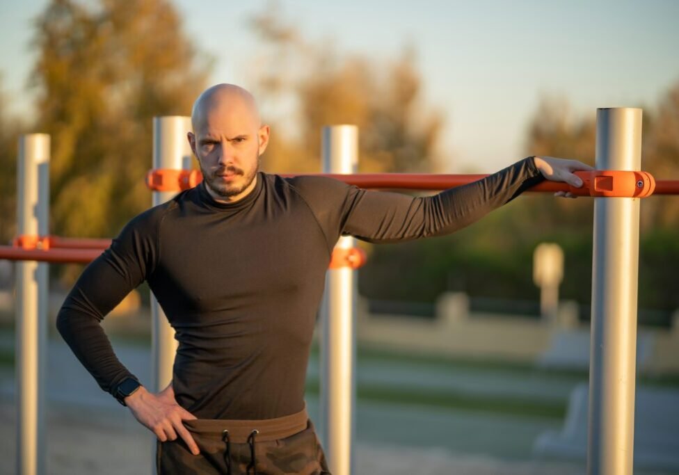 A young Hispanic man having a rest after working out in the sports ground